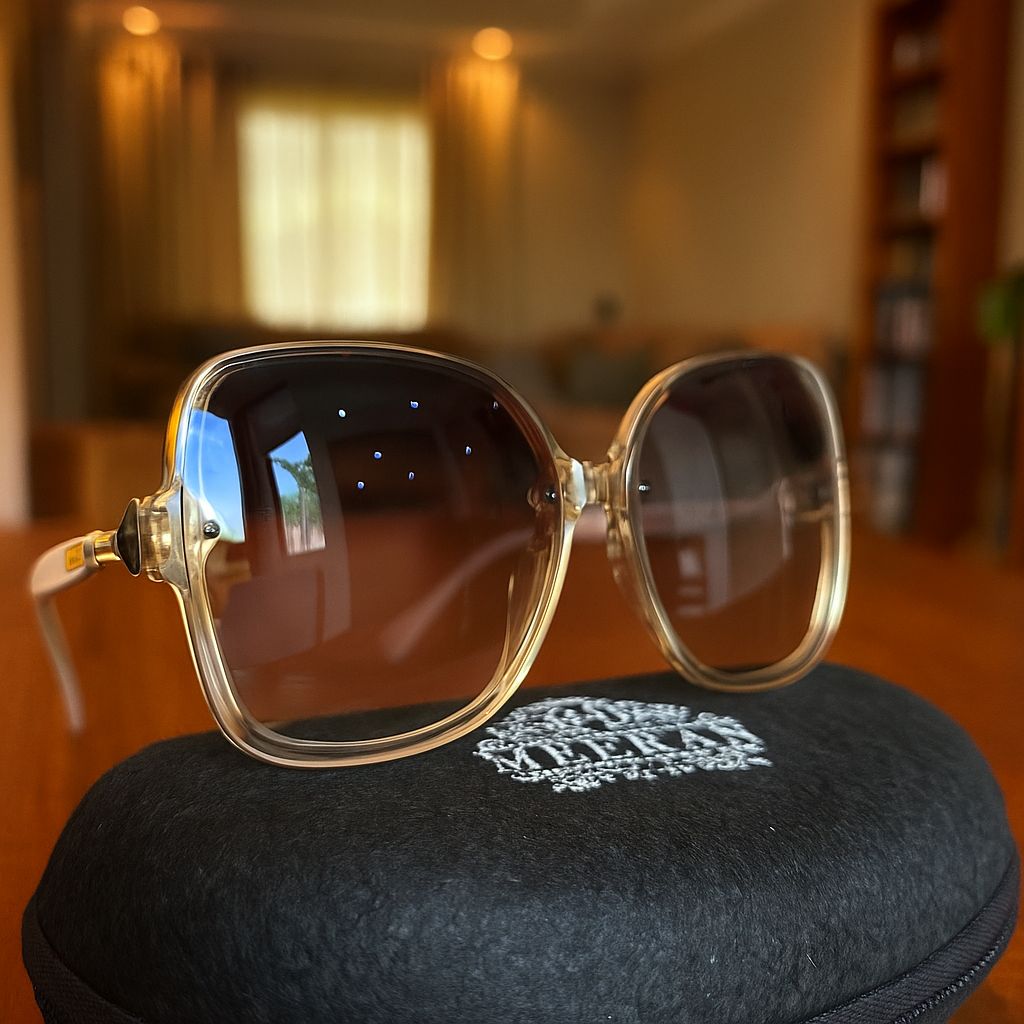 Meeran Charm sunglasses with black gradient lenses and a cream frame, featuring UV protection.